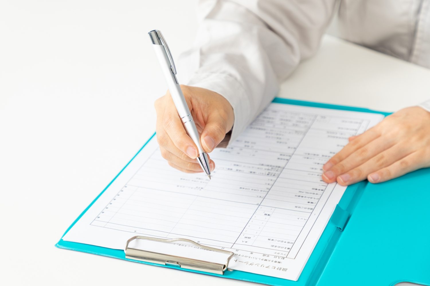 シートに記入する女性の手元02