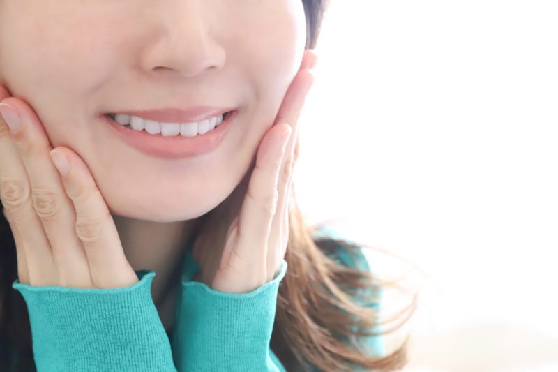 頬を手に当てる女性